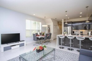 Relax in this stylish living space with a flat-screen TV, dining area, and fully equipped kitchen.