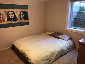 A bedroom with a bed, a window, and a poster on the wall. - Beautiful private 2 bedrooms/1 bathroom near campus (Boulder)