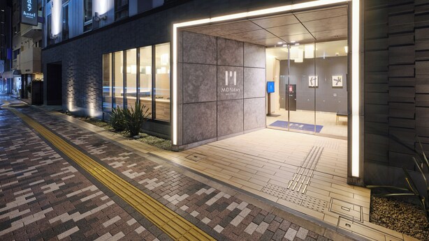 A modern hotel entrance with a glass facade, a clear pathway, and a visible reception desk. - hotel MONday Asakusa (Tokyo)