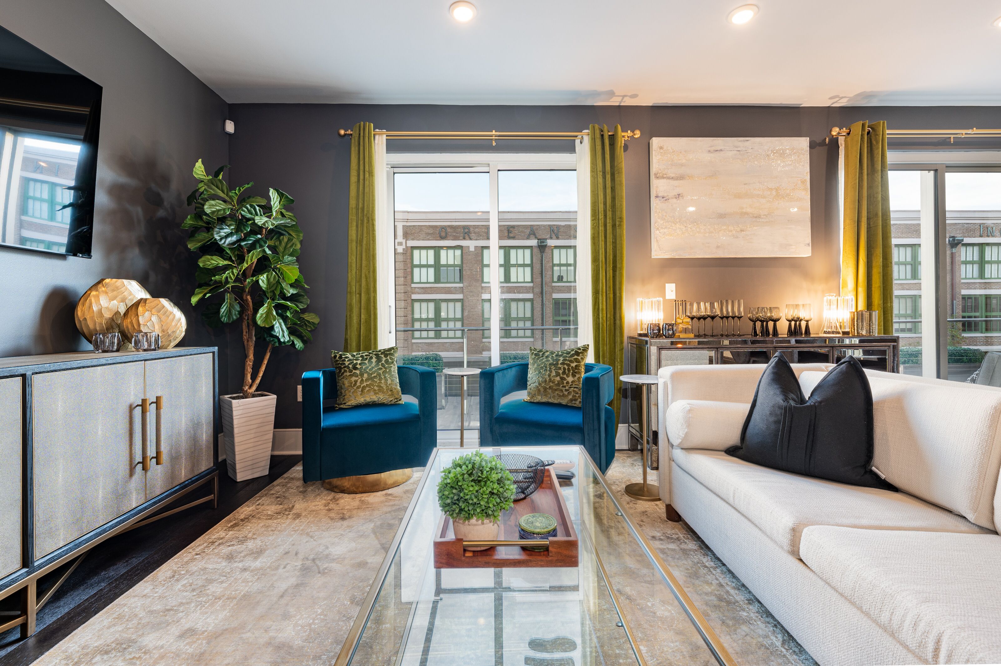 A modern living room with a sofa, armchairs, a coffee table, and a cabinet.