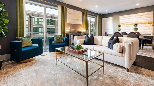 A modern living room with a glass coffee table, blue and white sofas, and large windows with curtains. - ⚜️Stylish,Spacious & Comfortable Downtown Penthouse! Enjoy The View from Your Personal Terrace! (New Orleans)