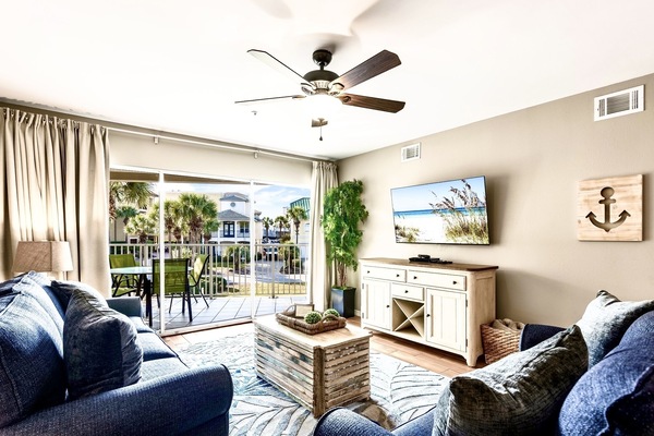 Spacious and airy - living room has full wall of sliding doors & smart TV.