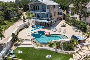 A two-story house with a swimming pool, outdoor seating, and a well-maintained lawn. - Large family home of Lake Travis with Pool
Perfect Place for a family reunion (Austin)