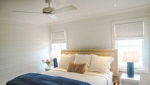 A bedroom with a bed, a ceiling fan, a nightstand with a lamp, and a window with blinds. - Home Away from Home! Beautiful Carriage House in Seagrove Close to the Beach (Santa Rosa Beach)