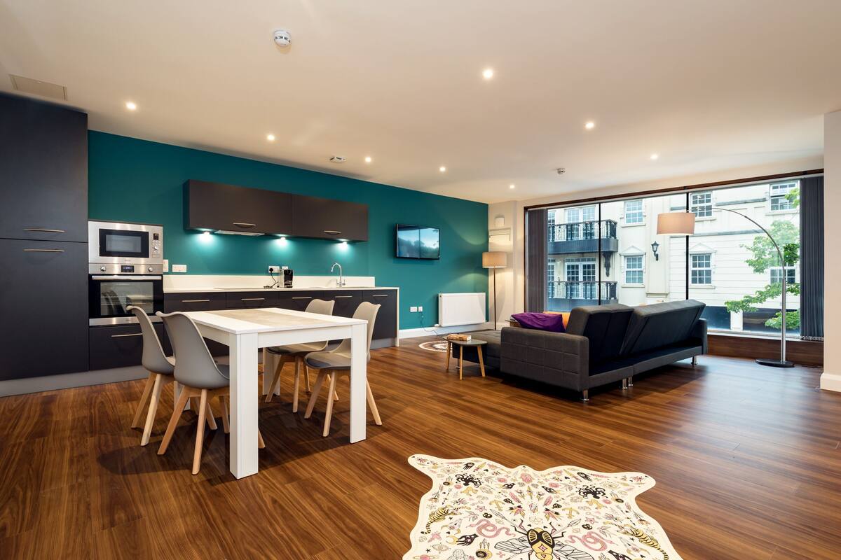 A modern living space with a kitchen, dining area, and seating area.