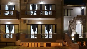A multi-story building with balconies, air conditioning units, and a staircase leading to an upper level. - Katerina Apartments 1 (Chania)