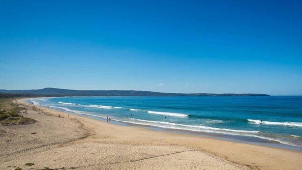 A beach with clear blue water and a sandy shore. - DRIFTWOOD SEVENTEEN BOOROO (Pambula Beach)