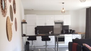 Een modern appartement met keuken, eetgedeelte en woonkamer.