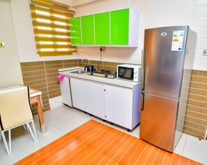 Apartment | Private kitchen | Fridge, microwave, cookware/dishes/utensils, cleaning supplies - Regency Apartment (Dar es Salaam)