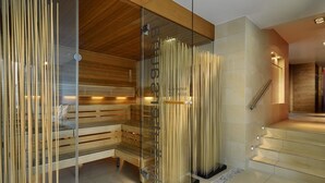A modern interior with a glass partition, wooden benches, and a staircase. - Berghotel Maibrunn (Sankt Englmar)
