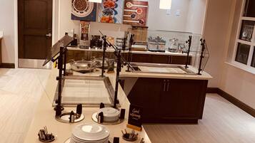 Una cocina moderna con una isla central, equipada con diversos electrodomésticos y utensilios.