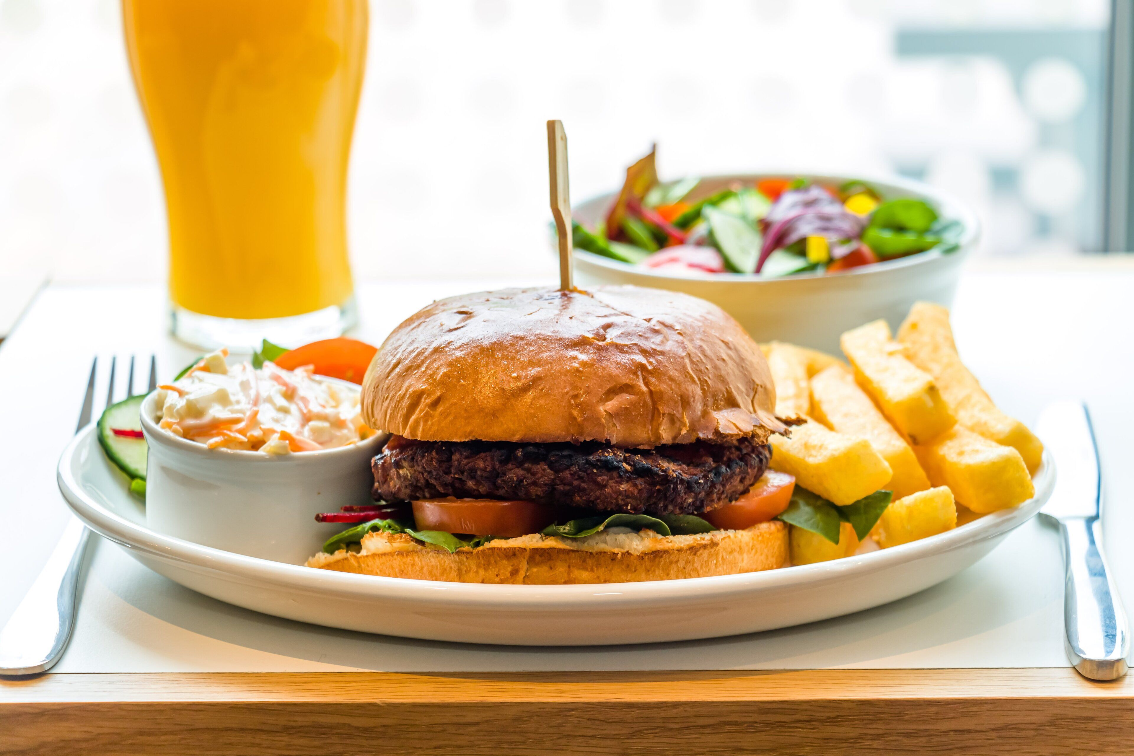 A plate with a burger, fries, and a salad.