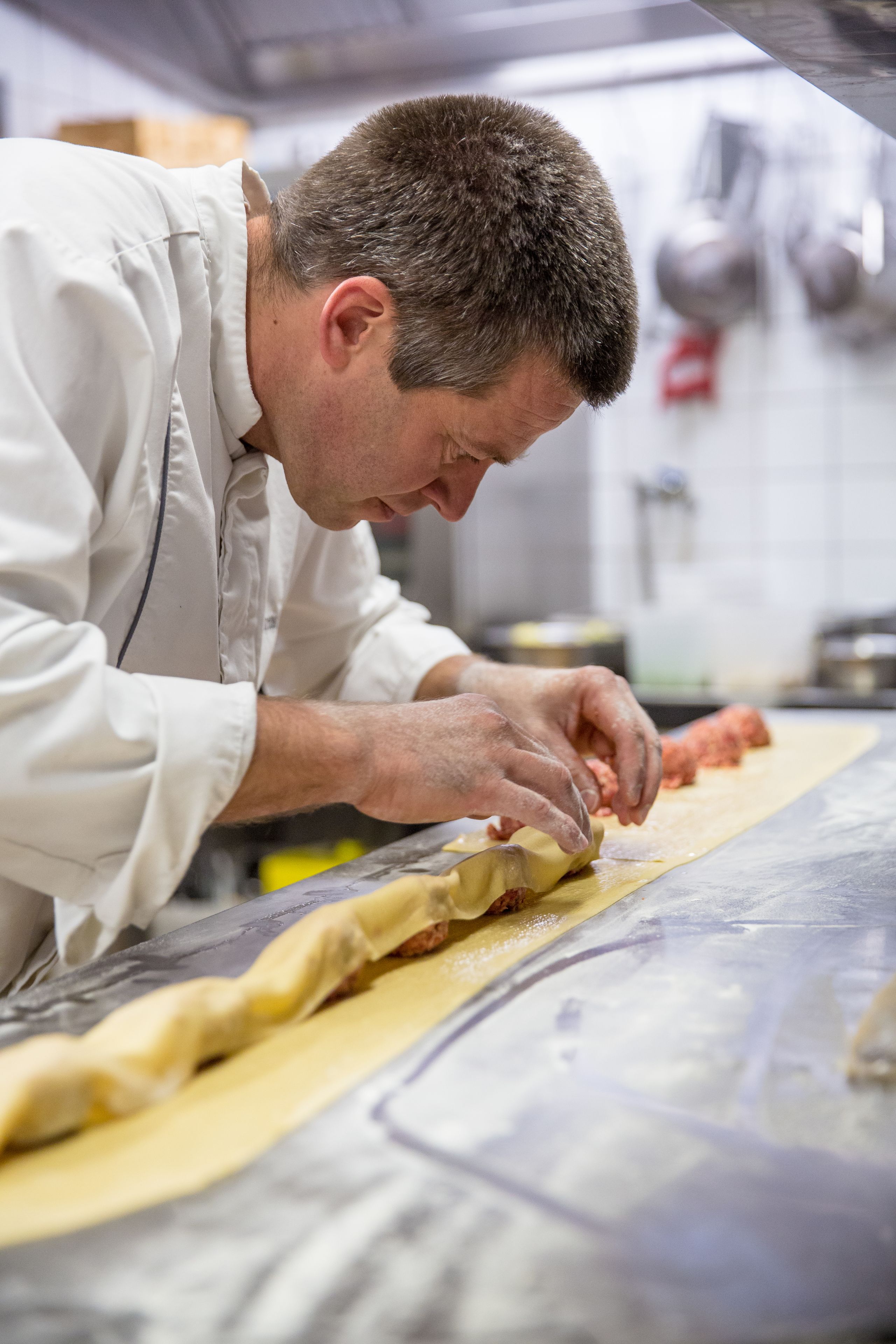 A chef preparing food in a kitchen.