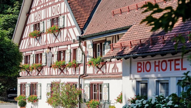 A traditional half-timbered building with a sign reading "BIO HOTEL". - BIO-Hotel Adler (Vogt)