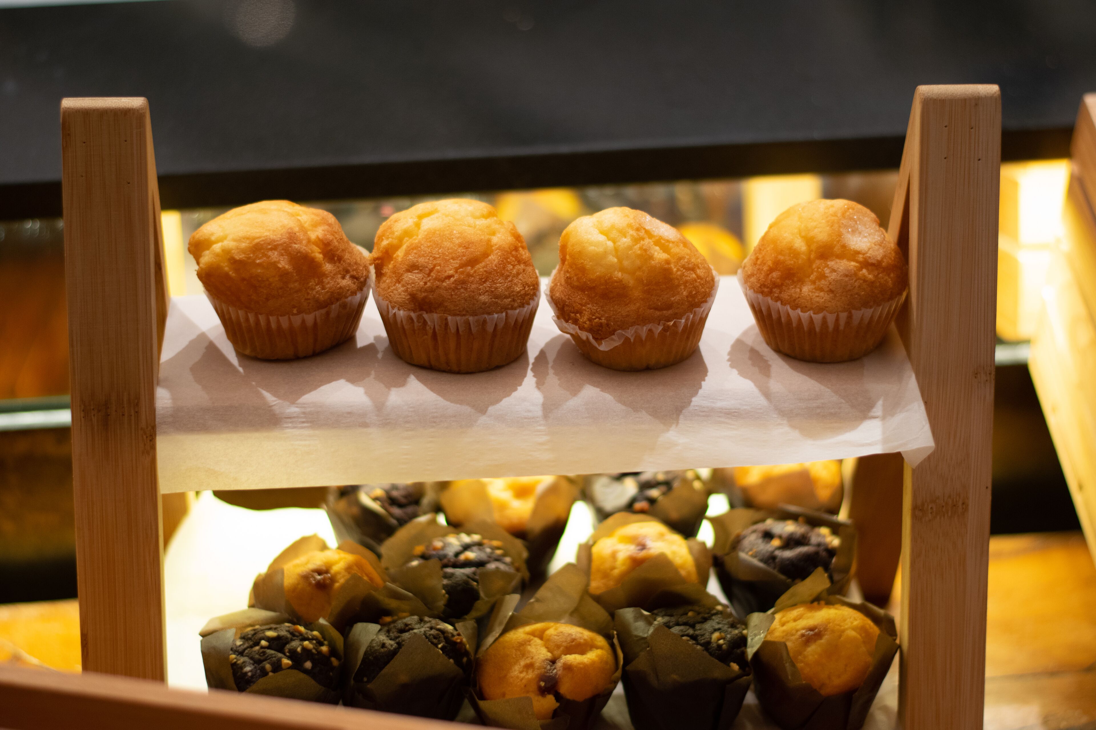 A display of muffins in a bakery.