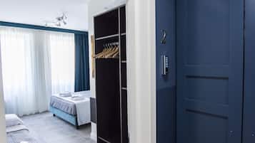 Economy Triple Room | Minibar, in-room safe, desk, laptop workspace