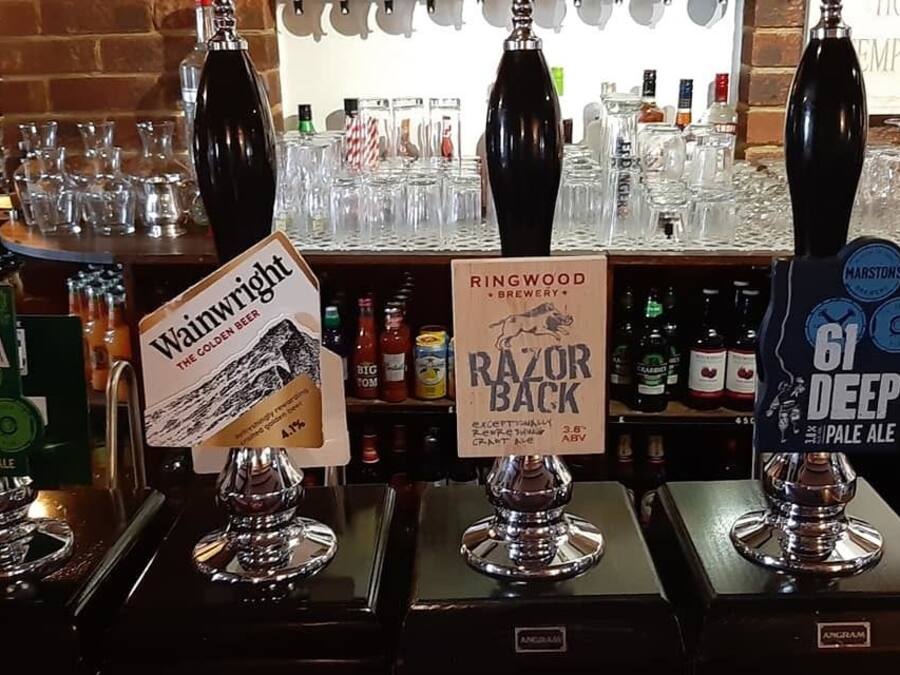 A bar with four taps labeled EPA, Wainwright, Razorback, and Marston's 61 Deep.