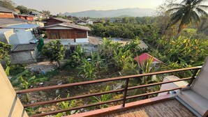 A residential area with houses, a balcony, and a view of distant mountains. - Sandee Place Mountain View Chomthong (Chom Thong)