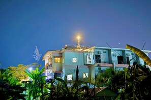 A multi-story building with a central tower, surrounded by greenery. - Sandee Place Mountain View Chomthong (Chom Thong)