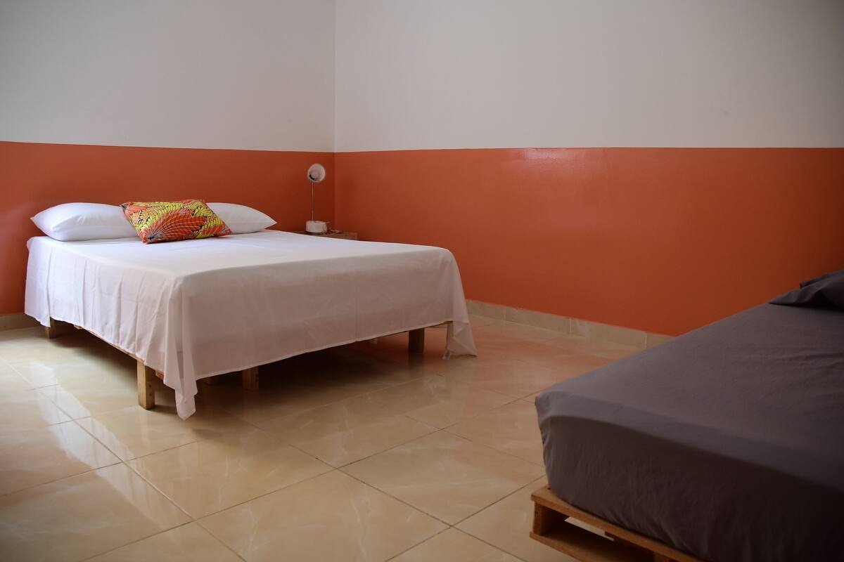 A room with a bed, a nightstand, and a bedside table.