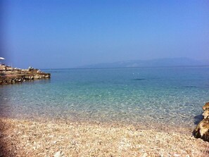 Enjoy the serene beach atmosphere with clear waters and a natural shoreline.