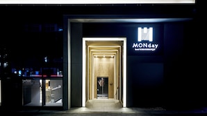 La fachada de la entrada de un hotel con un letrero que dice 'Monday Hotel Karasumanijo'.
