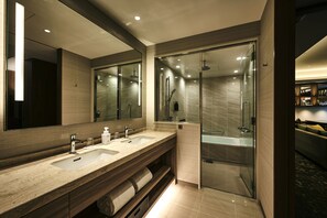 A modern bathroom with dual sinks, a large mirror, and a glass-enclosed shower area. - The Royal Park Hotel Iconic Osaka Midosuji (Osaka)