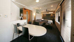 A compact, modern room with a dining area, a sofa, and a bed. - Zonk Hotel Nakasu (Fukuoka)
