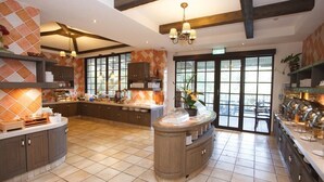 A spacious kitchen with a central island, large windows, and a chandelier. - King's Garden Villa (Tainan)