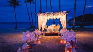 A beach wedding setup with a canopy, chairs, and lanterns. - Belmont Hotel Boracay near Newcoast Beach (Boracay Island)
