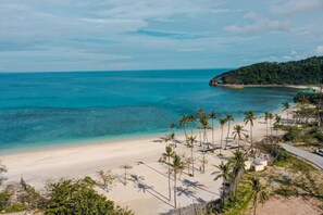 A beach with clear turquoise waters, palm trees, and a sandy shore. - Belmont Hotel Boracay near Newcoast Beach (Boracay Island)