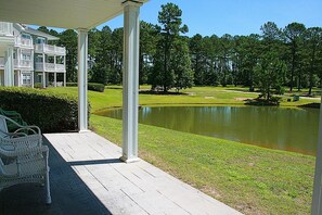 A covered outdoor area with a view of a pond and a golf course. - Calabash, NC, Brunswick Plantation, 1 Bedroom/1Bathroom, nearby beaches(2402M) (Calabash)