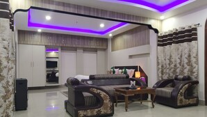 A modern living room with a sofa set, a coffee table, and a TV.