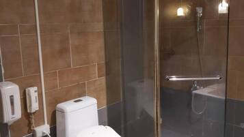 Separate bathtub and shower, free toiletries, hair dryer, slippers