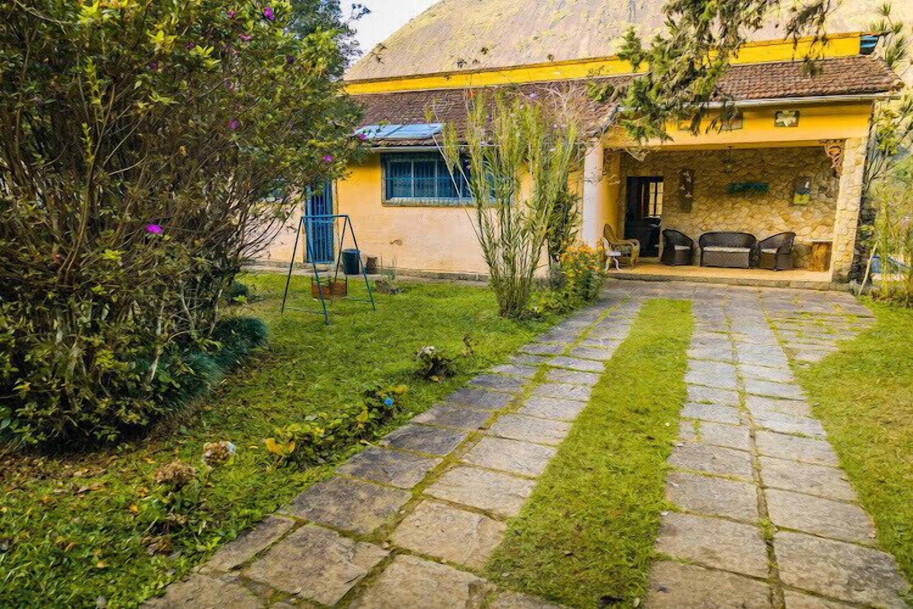 A house with a stone pathway leading to a covered patio area.