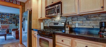 Wanderlust Elegant Townhome includes Rustic Stone Fireplace by RedAwning