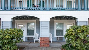 A two-story building with a balcony, two doors, and a brick pillar. - Comfortable 09 Lodge Condo Minutes Away from Downtown Hood River by RedAwning (Hood River)