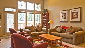 A living room with two sofas, a coffee table, and a bookshelf.
