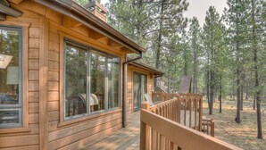A wooden cabin with large windows and a deck overlooking a forest. - 7 Cedar Private Cul-de-sac include Hot Tub with Forest View by RedAwning (Bend)