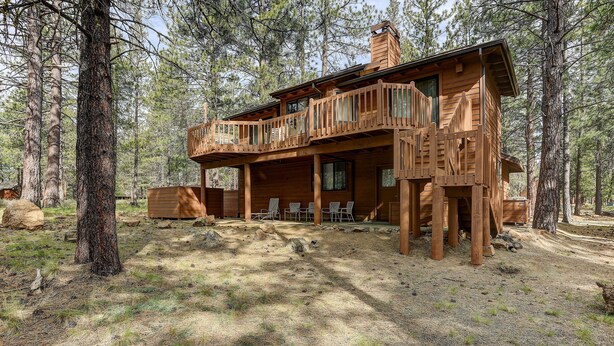 A wooden cabin with a balcony, surrounded by trees. - 7 Cedar Private Cul-de-sac include Hot Tub with Forest View by RedAwning (Bend)