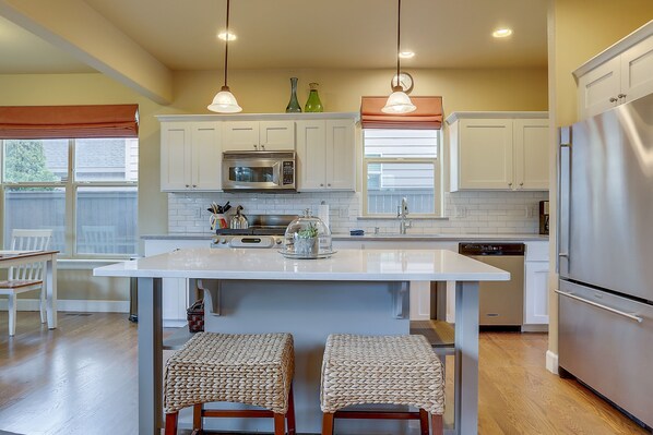Enjoy cooking in this well-lit kitchen with a central island and appliances.