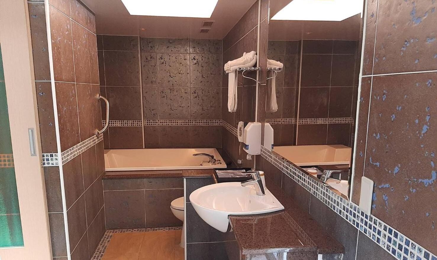 A bathroom with a bathtub, a sink, and a toilet.