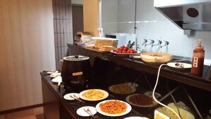 A buffet setup with various food items and a coffee machine. - Chateau Motel & Spa - Daliao (Kaohsiung)