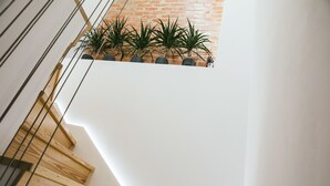 Un escalier avec des marches en bois menant à un mur blanc.