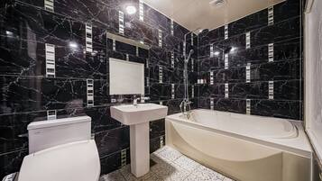 Combined shower/tub, free toiletries, hair dryer, slippers