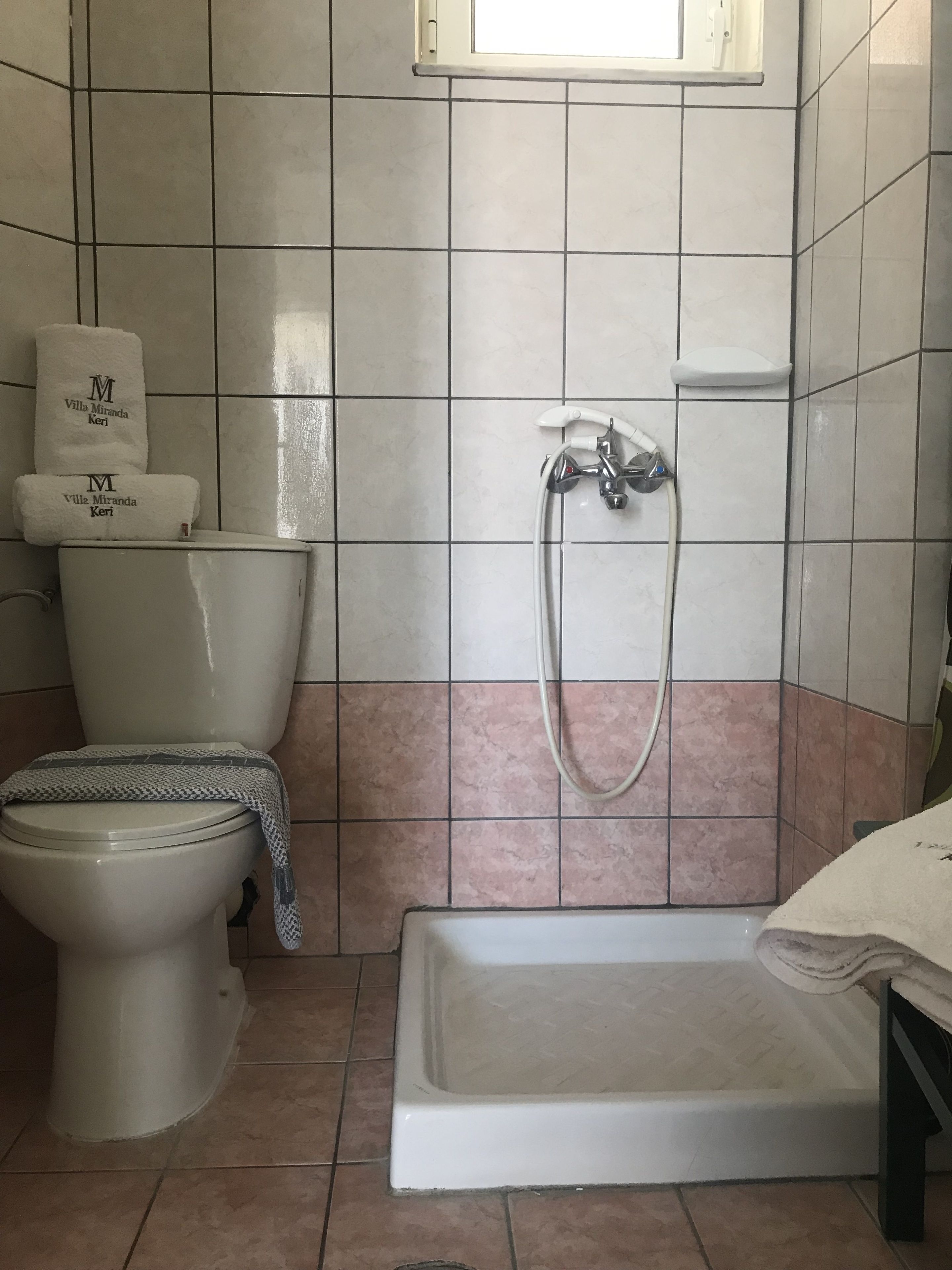 A bathroom with a toilet, a shower, and a bathtub.