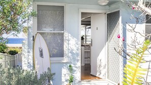 Enjoy the ocean view from this coastal retreat, where you can relax and unwind with a surfboard nearby.