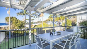 Enjoy dining al fresco with a view of the surrounding landscape from this outdoor balcony.