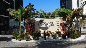 A sign for 'Island Winds' with a view of the surrounding buildings and landscaping.
