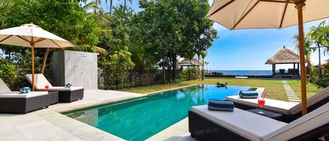 An infinity pool, pool loungers